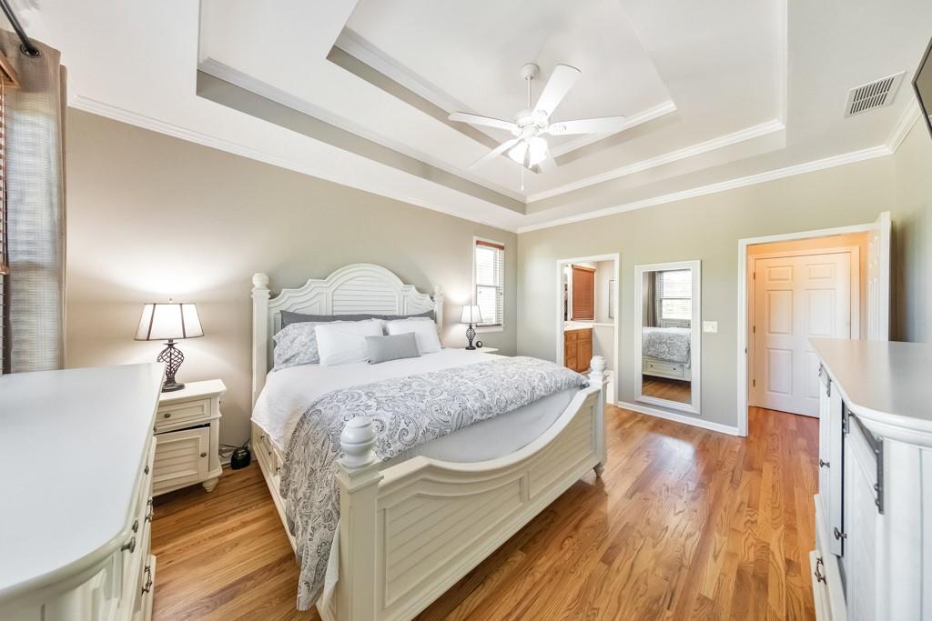 304 Turning Leaf Court Canton, GA 30115 - Photo 25 of 73 a bedroom with a bed and wooden floor
