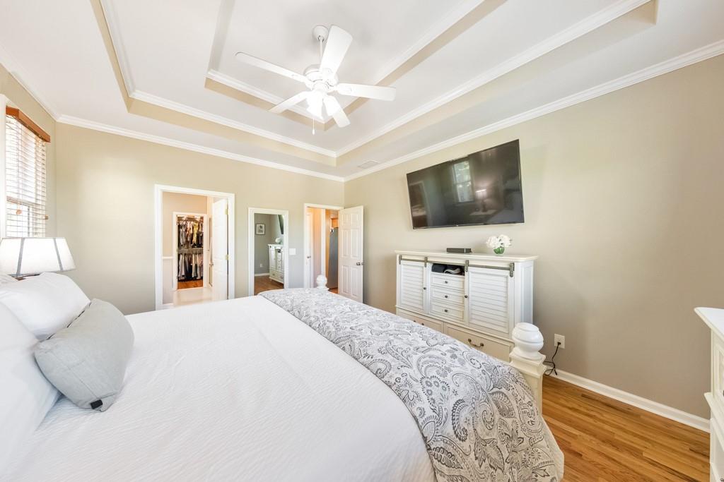 304 Turning Leaf Court Canton, GA 30115 - Photo 26 of 73 a spacious bedroom with a bed and a flat screen tv