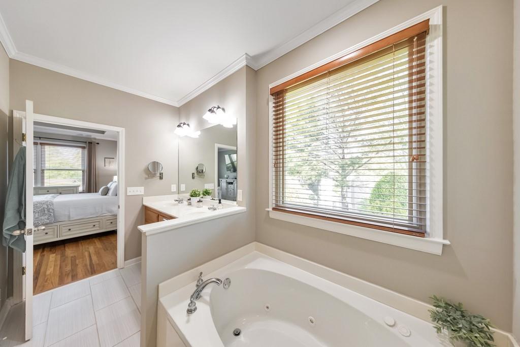 304 Turning Leaf Court Canton, GA 30115 - Photo 28 of 73 a bathroom with a bathtub and a sink