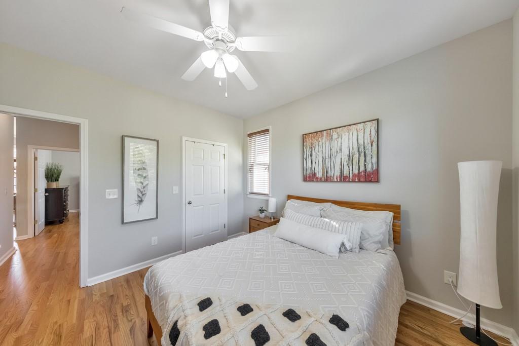 304 Turning Leaf Court Canton, GA 30115 - Photo 31 of 73 a bedroom with a large bed and a chandelier