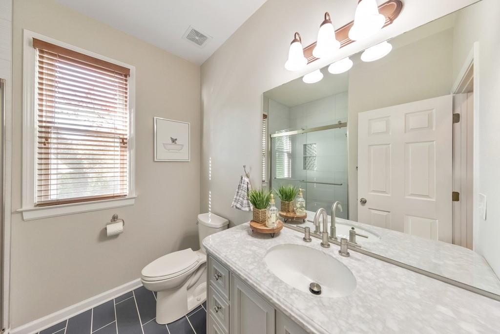 304 Turning Leaf Court Canton, GA 30115 - Photo 32 of 73 a bathroom with a sink a toilet and a mirror