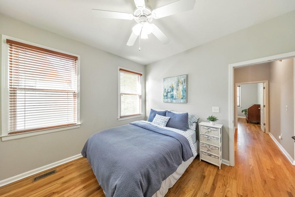 304 Turning Leaf Court Canton, GA 30115 - Photo 34 of 73 a bedroom with a bed and wooden floor