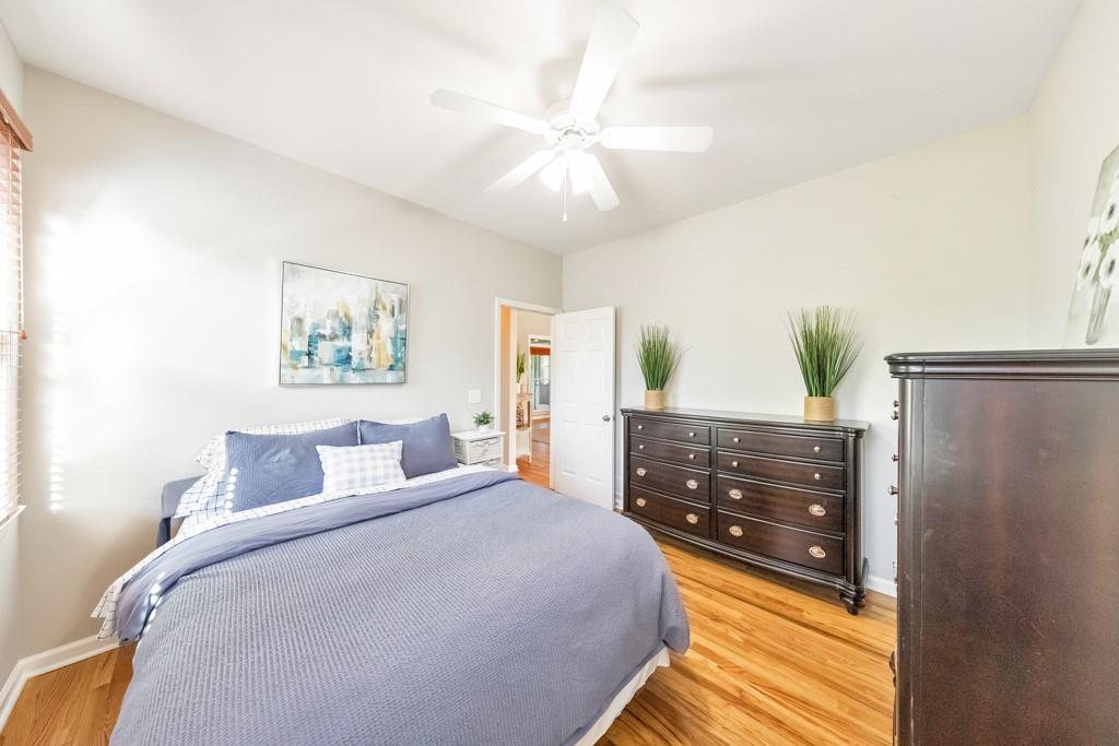 304 Turning Leaf Court Canton, GA 30115 - Photo 35 of 73 a bedroom with a large bed and a chandelier