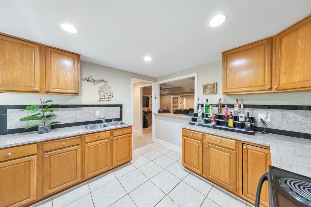 304 Turning Leaf Court Canton, GA 30115 - Photo 44 of 73 a kitchen with stainless steel appliances granite countertop sink stove and cabinets