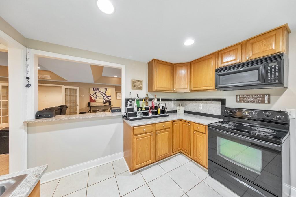 304 Turning Leaf Court Canton, GA 30115 - Photo 45 of 73 a kitchen with stainless steel appliances granite countertop a stove a sink and a microwave