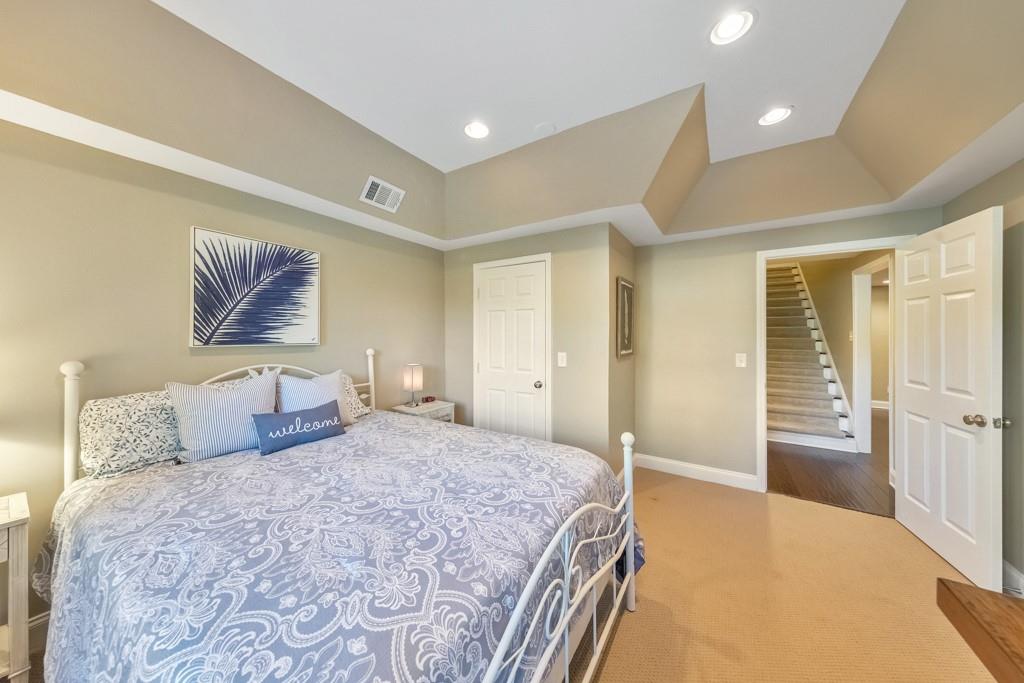 304 Turning Leaf Court Canton, GA 30115 - Photo 47 of 73 a bedroom with a large bed and a couch