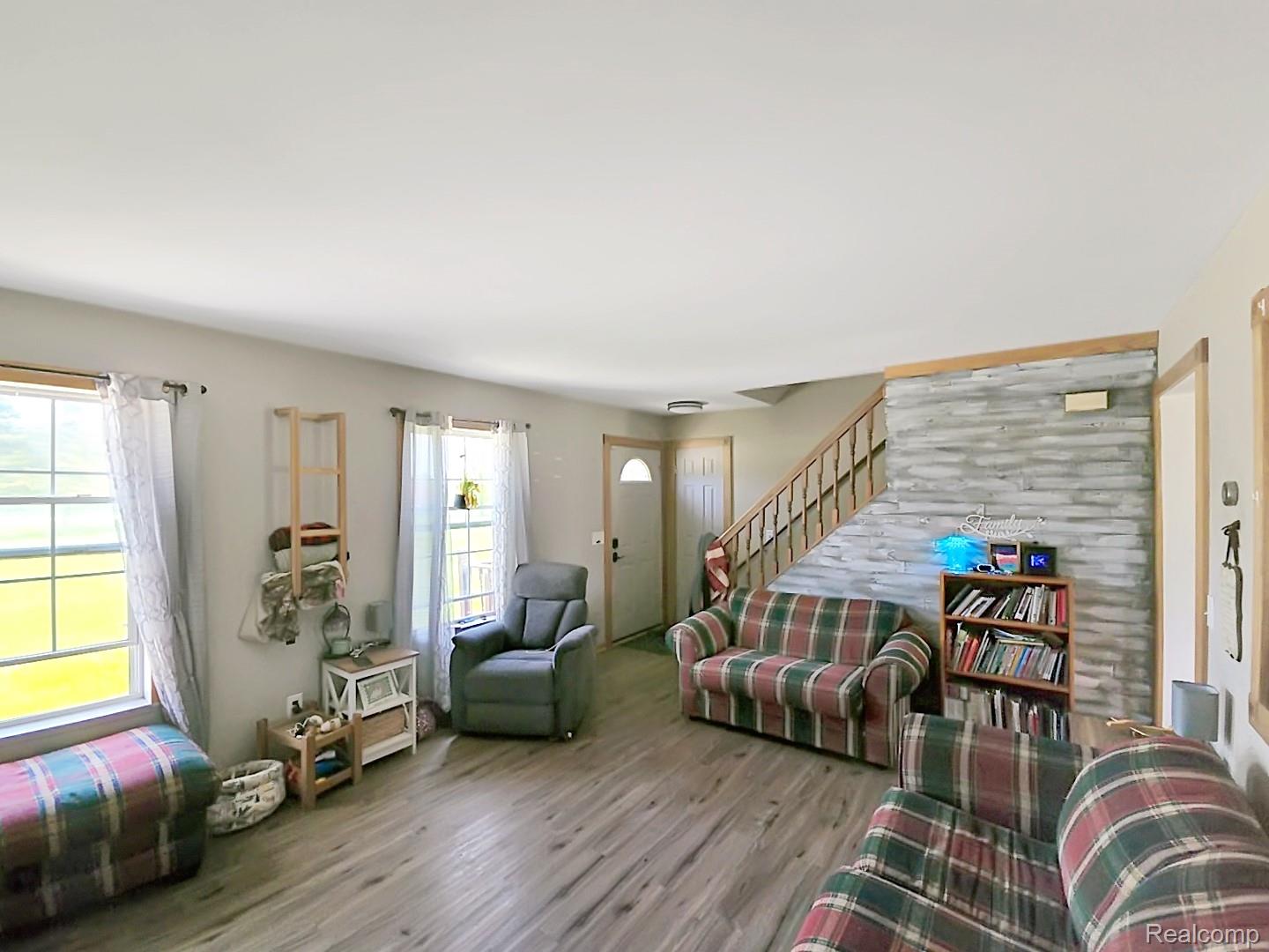 6533 Kilburn Road Jeddo, MI 48032 - Photo 8 of 19 Living room featuring wood finished floors and stairs