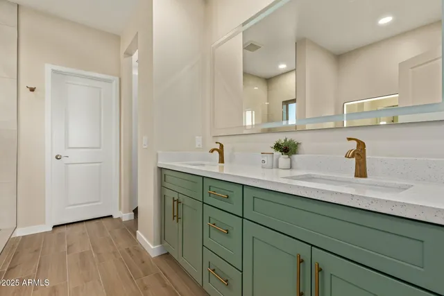 a spacious bathroom with a double vanity sink and mirror