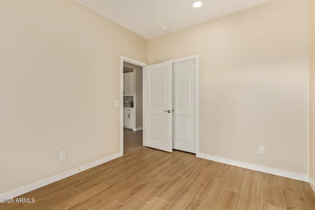 a view of an empty room with wooden floor