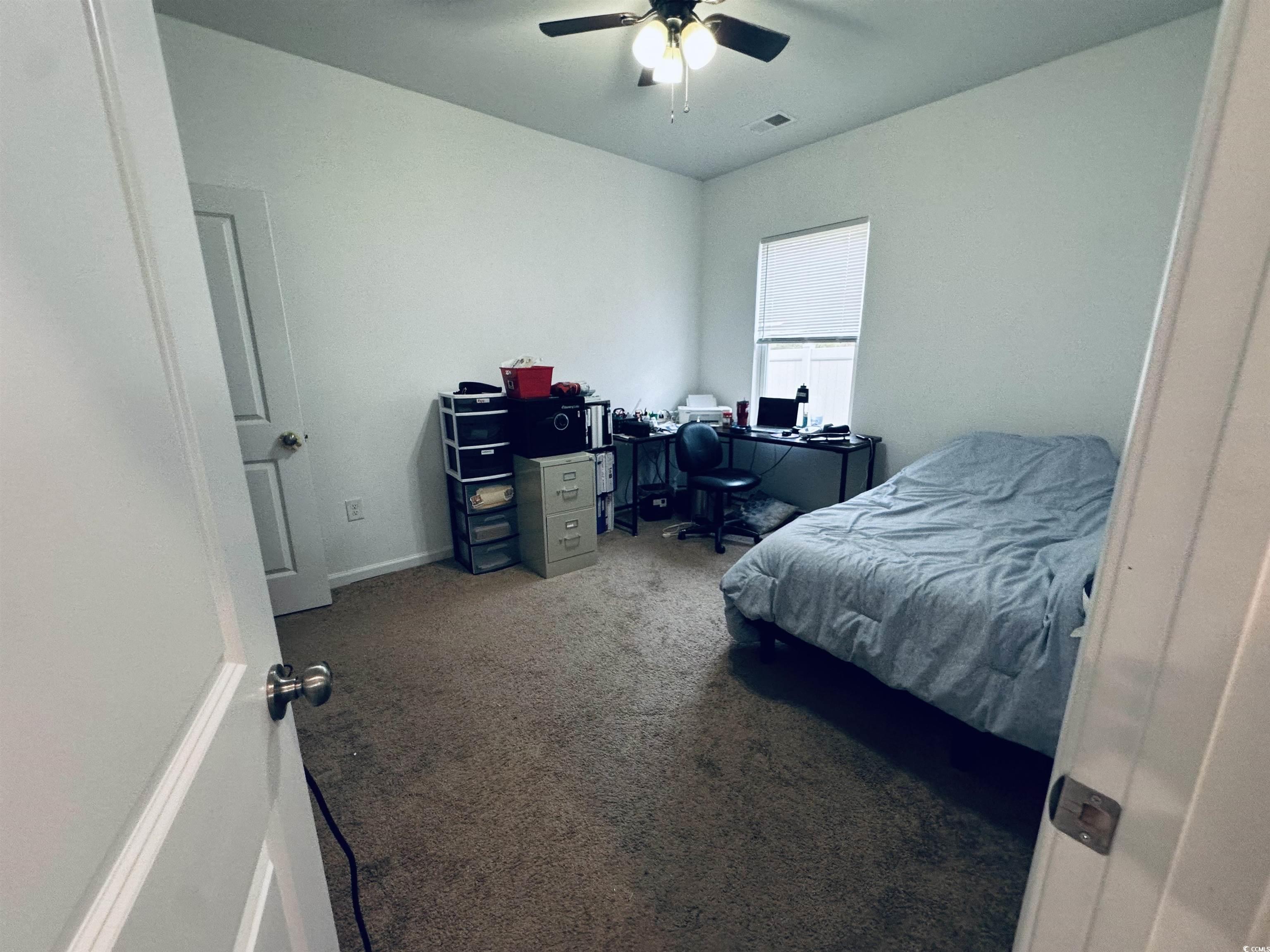 5260 Walnutwood Trail Myrtle Beach, SC 29579 - Photo 16 of 30 Bedroom featuring carpet, a ceiling fan, and a desk