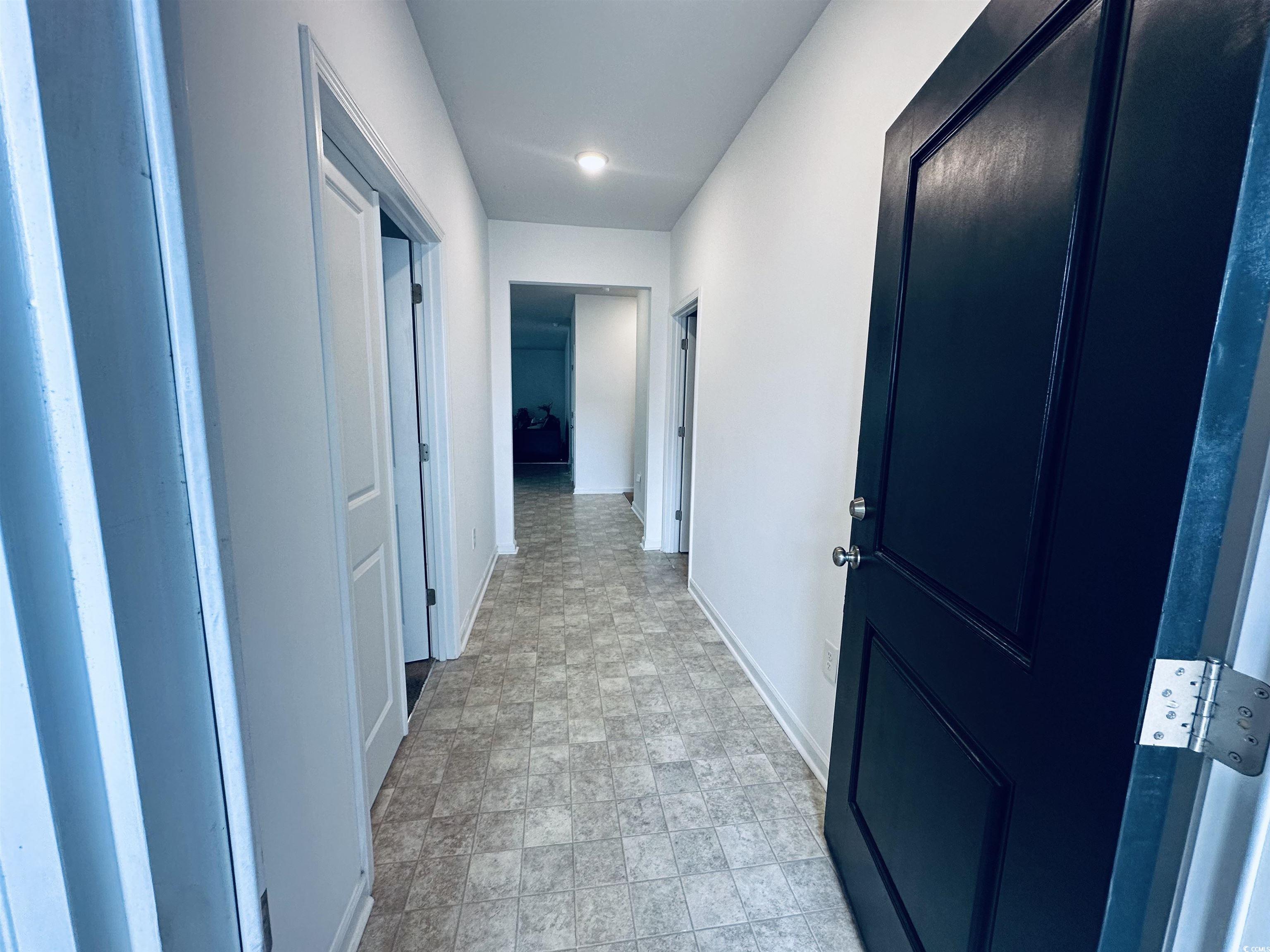 5260 Walnutwood Trail Myrtle Beach, SC 29579 - Photo 2 of 30 Hallway with baseboards and stone finish flooring