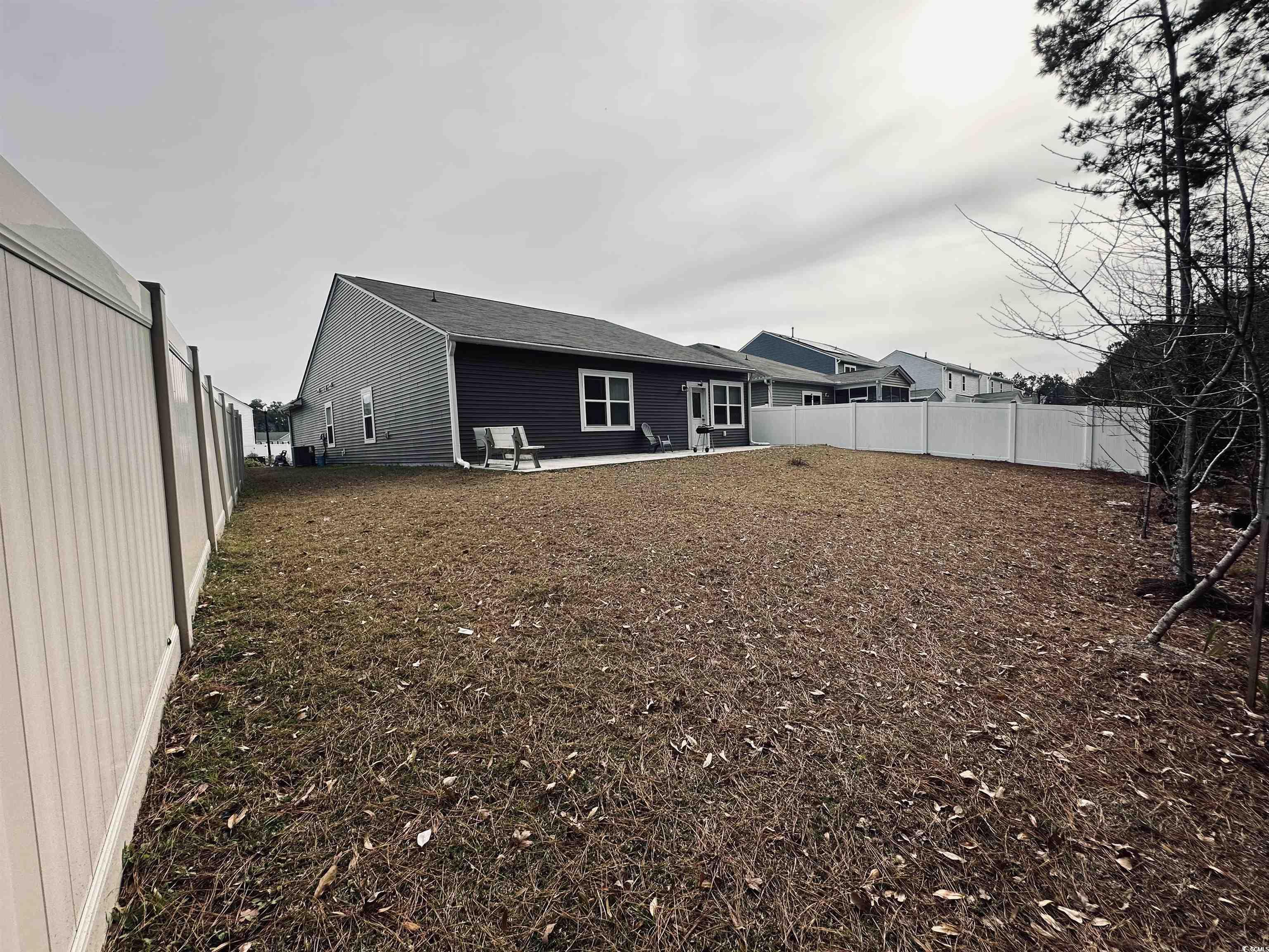 5260 Walnutwood Trail Myrtle Beach, SC 29579 - Photo 21 of 30 Back of property with a fenced backyard and a patio area