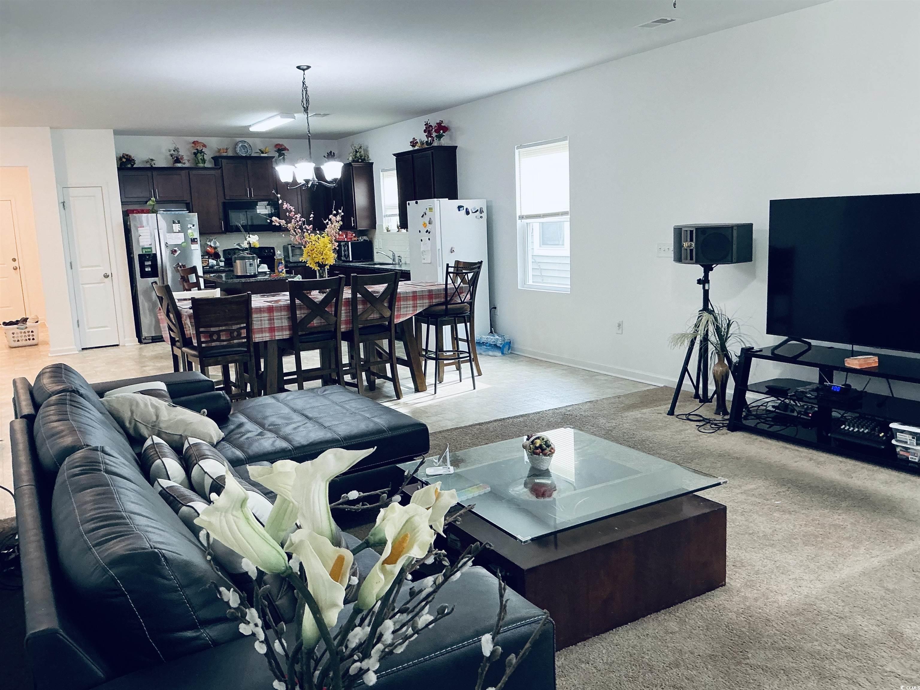 5260 Walnutwood Trail Myrtle Beach, SC 29579 - Photo 8 of 30 Living area with light carpet and a chandelier