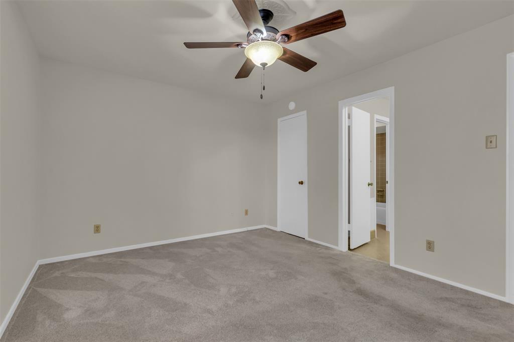 10763 Villager Road, Unit A Dallas, TX 75230 - Photo 14 of 21 an empty room with a ceiling fan and a window
