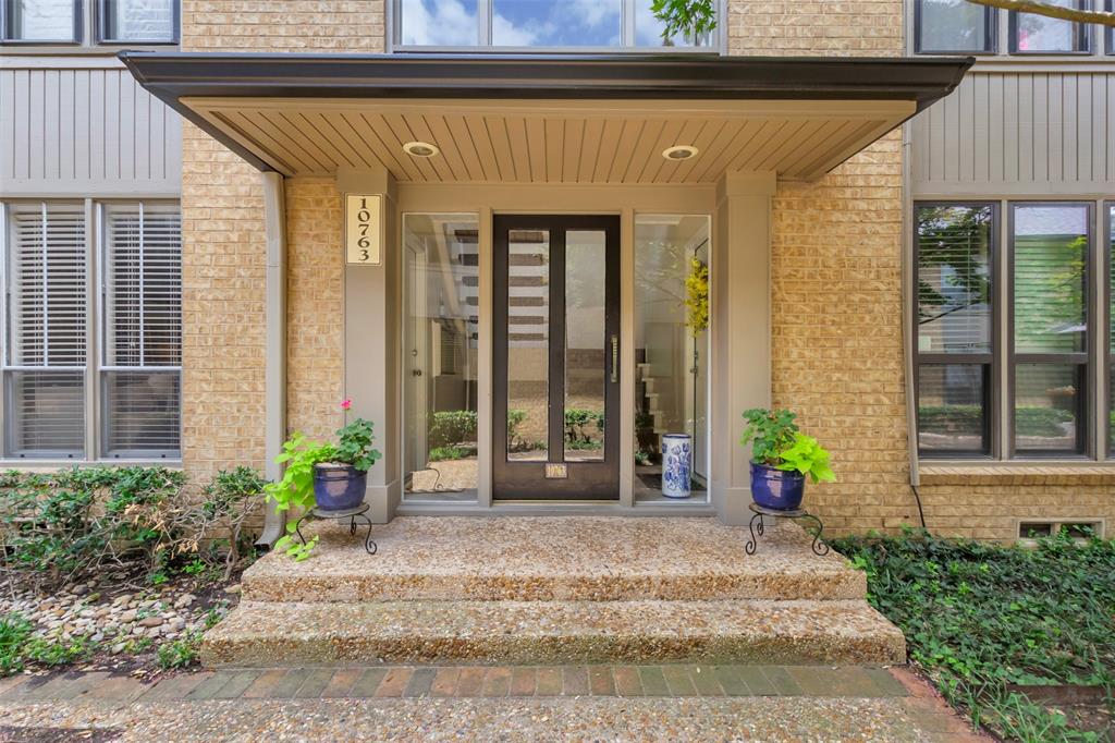 10763 Villager Road, Unit A Dallas, TX 75230 - Photo 3 of 21 a front view of a house with a garden