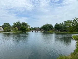 a white house with river in front of it