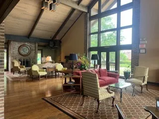 a living room with furniture and a clock