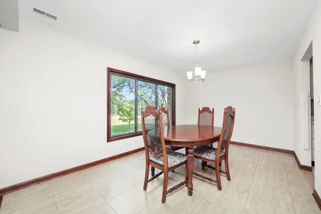 a view of a dining room with furniture and a window