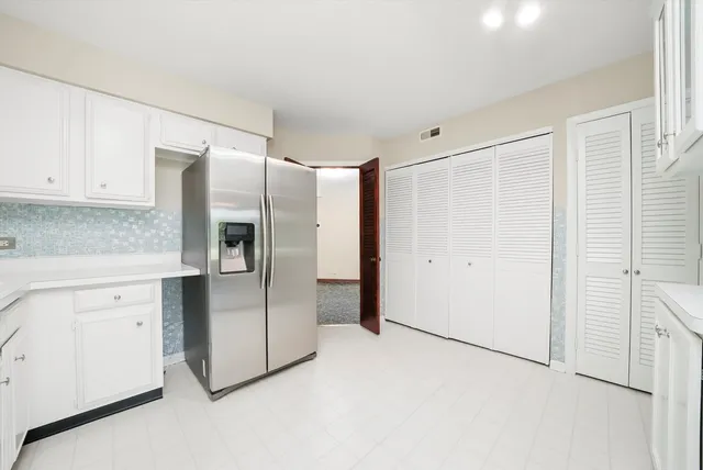 a kitchen with cabinets and stainless steel appliances