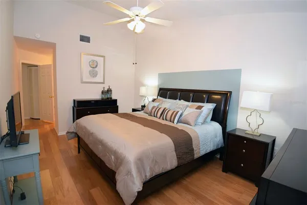 a bed room with a bed tv and a mirror