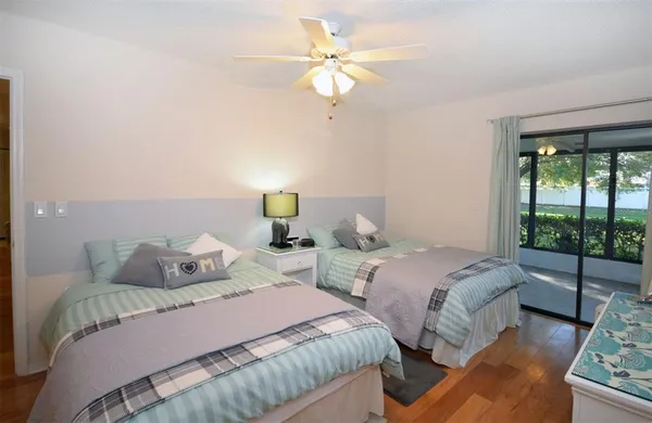 a bedroom with two beds and large window