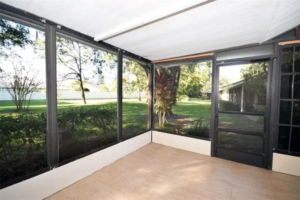 a view of a porch with furniture and garden