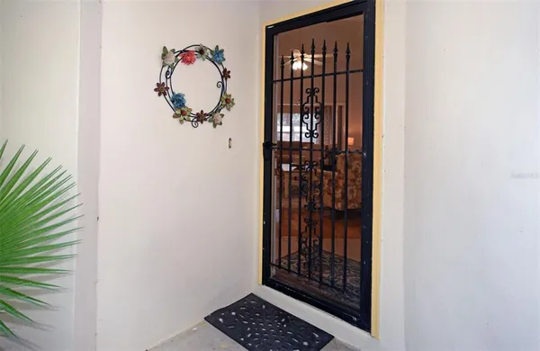 a view of a hallway with wooden floor and a potted plant