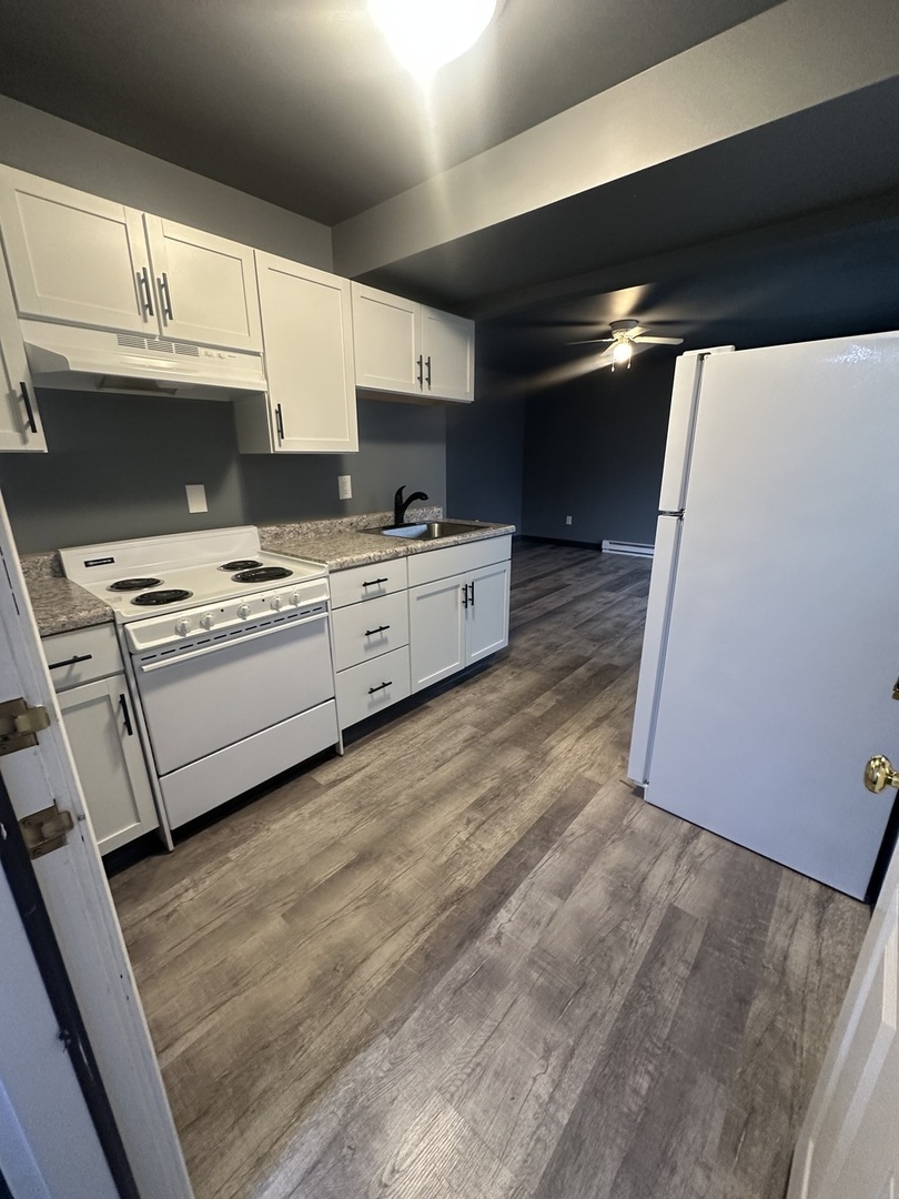 530 East 3rd Street, Unit F Coal City, IL 60416 - Photo 2 of 5 a kitchen with stainless steel appliances a stove a sink and a microwave