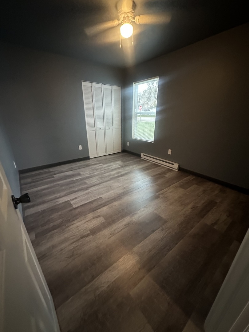 530 East 3rd Street, Unit F Coal City, IL 60416 - Photo 3 of 5 en empty room with windows and ceiling fan