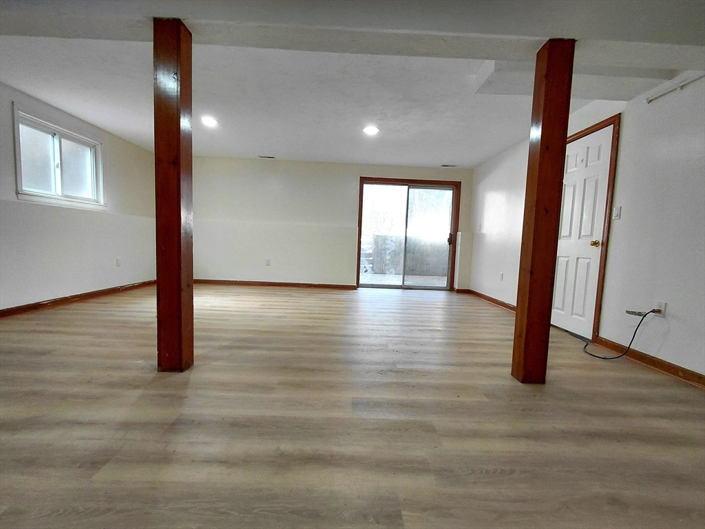 117 Metropolitan Avenue, Unit 117 Ashland, MA 01721 - Photo 11 of 15 an empty room with wooden floor and entryway