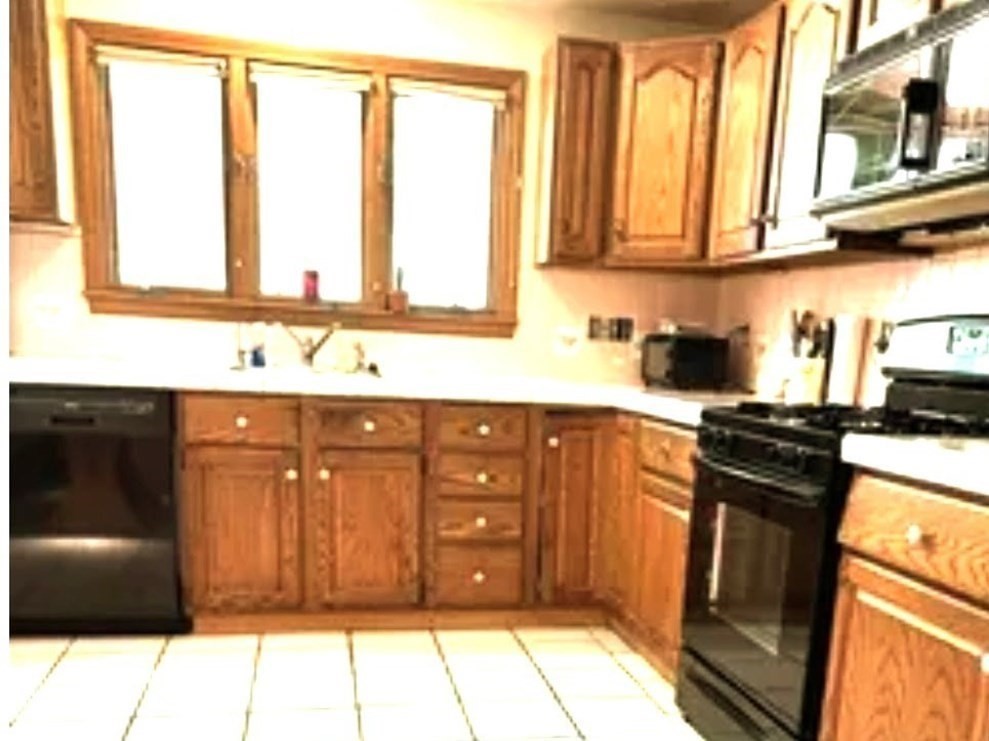 117 Metropolitan Avenue, Unit 117 Ashland, MA 01721 - Photo 3 of 15 a kitchen with stainless steel appliances granite countertop a stove a sink and a microwave