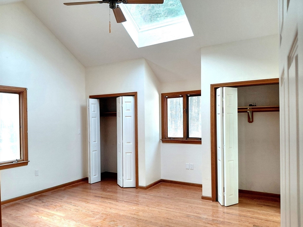 117 Metropolitan Avenue, Unit 117 Ashland, MA 01721 - Photo 5 of 15 an empty room with wooden floor and windows