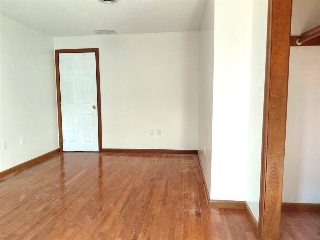 117 Metropolitan Avenue, Unit 117 Ashland, MA 01721 - Photo 6 of 15 a view of an empty room with wooden floor