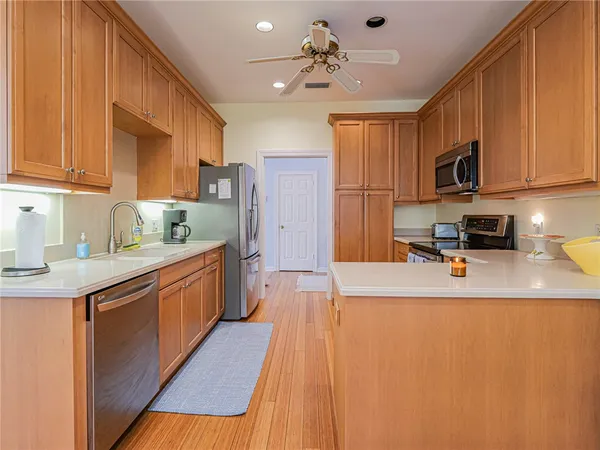 a kitchen with stainless steel appliances granite countertop a sink stove and refrigerator