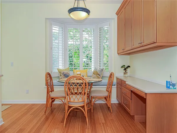 a dining room with furniture and wooden floor