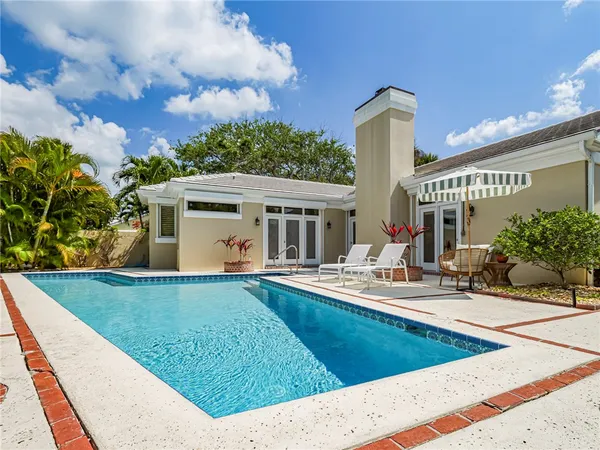 a view of a house with backyard sitting area and porch