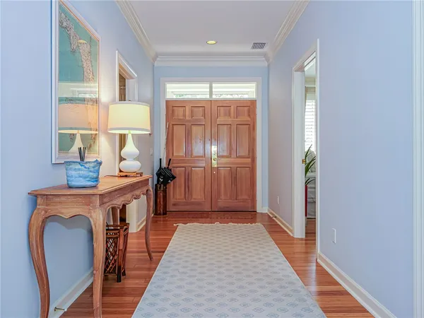 a view of a room with furniture and wooden floor