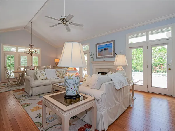 a living room with furniture a table and a large window