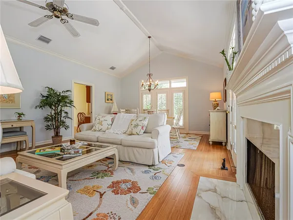 a living room with furniture a fireplace and a window