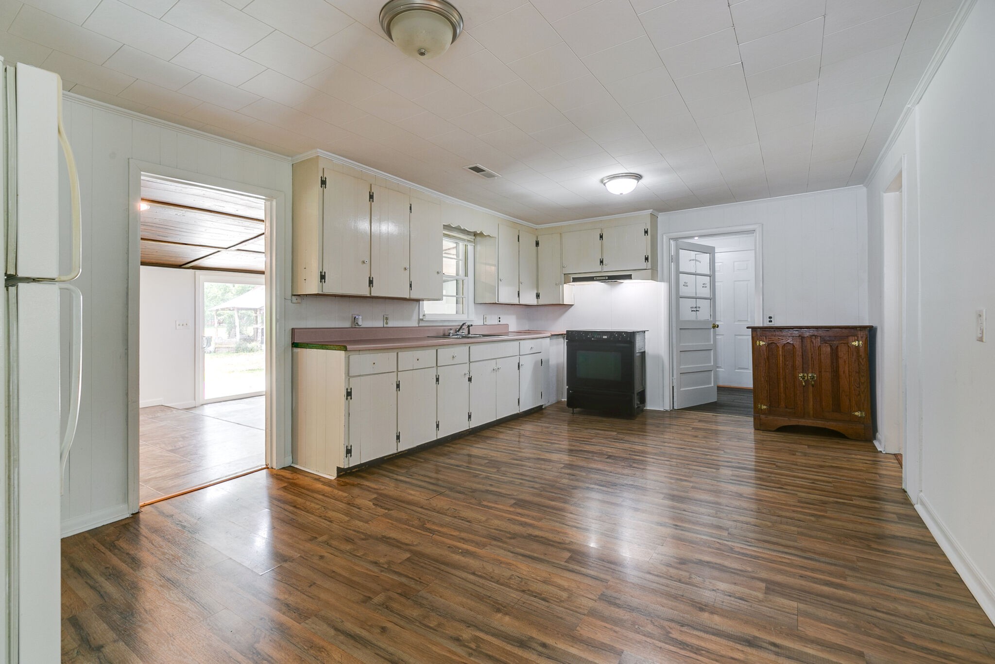 210 Old Rover Road Rockvale, TN 37153 - Photo 9 of 41 a large kitchen with wooden floors and white stainless steel appliances