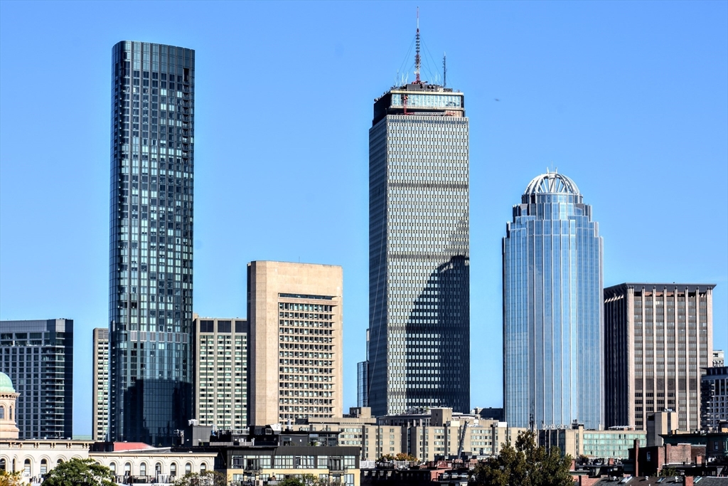 a view of balcony with tall buildings