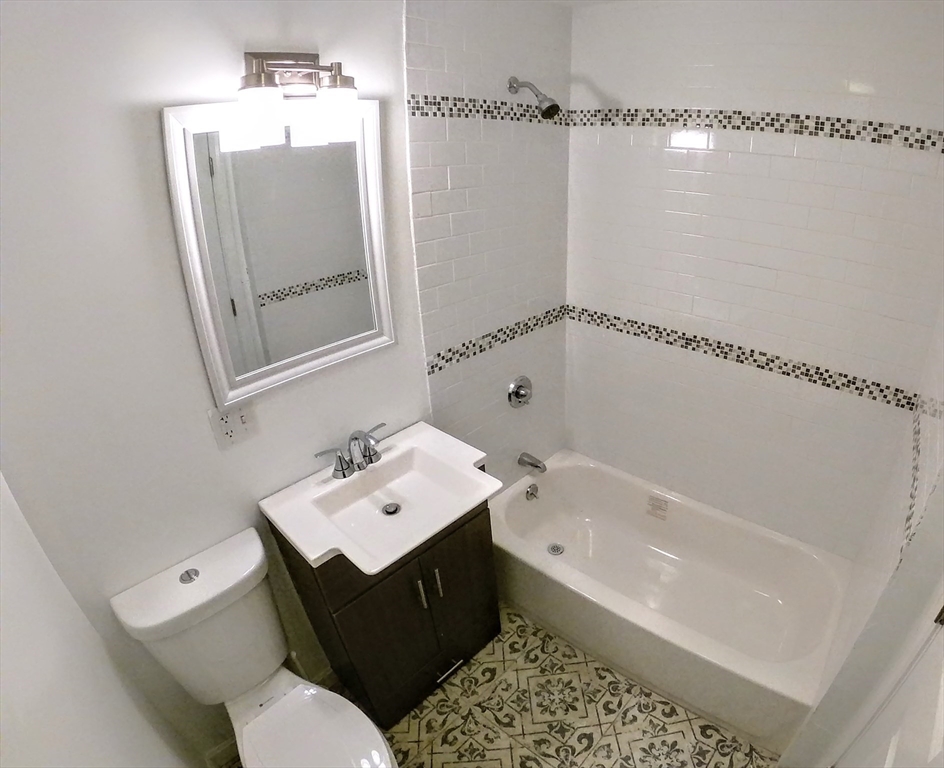 608 Shawmut Avenue, Unit 3 Boston, MA 02118 - Photo 18 of 22 a bathroom with a bathtub sink vanity and toilet