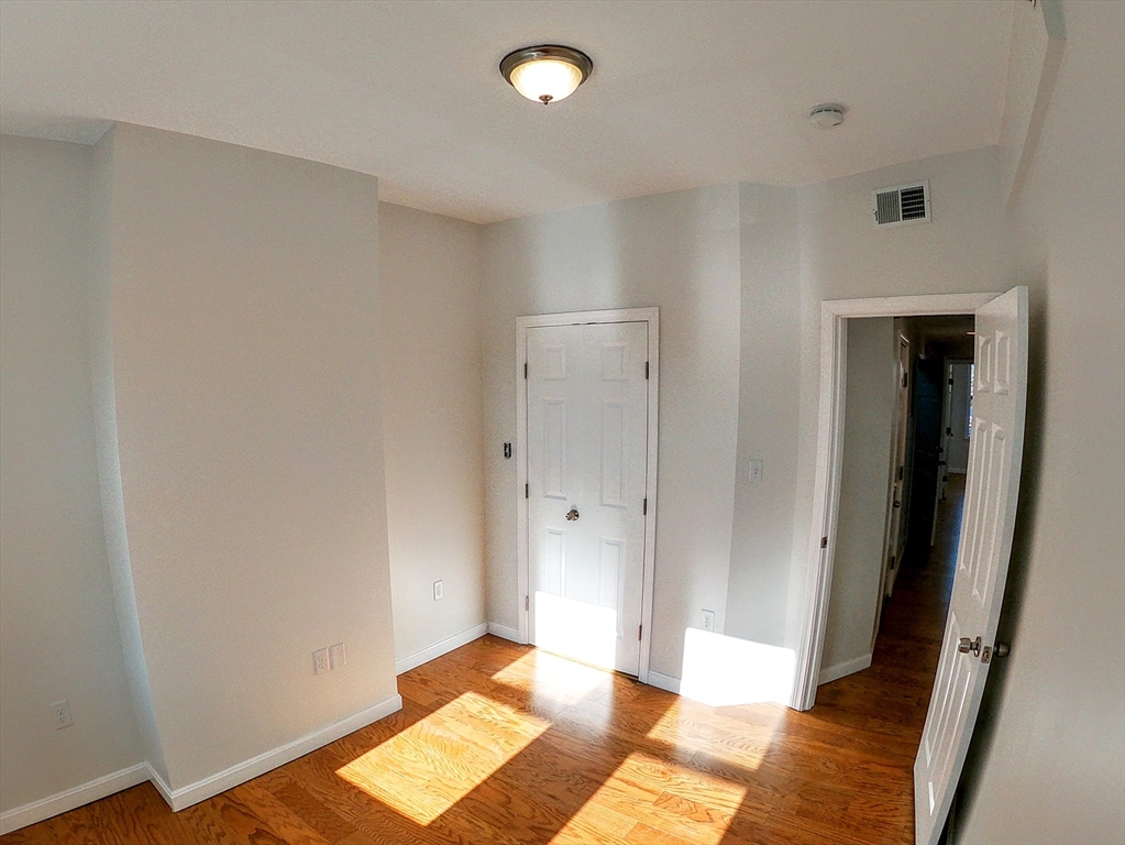 608 Shawmut Avenue, Unit 3 Boston, MA 02118 - Photo 20 of 22 a view of an empty room and wooden floor