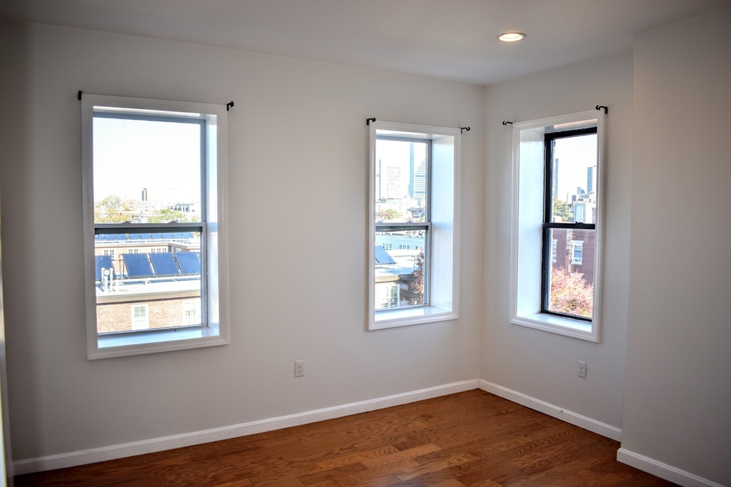 608 Shawmut Avenue, Unit 3 Boston, MA 02118 - Photo 6 of 22 a view of an empty room with wooden floor and a window