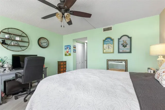 a front view of a building with glass windows and a yard