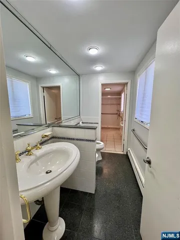 a kitchen with granite countertop white cabinets and stainless steel appliances