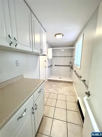 a view of a hallway with wooden floor and a chandelier