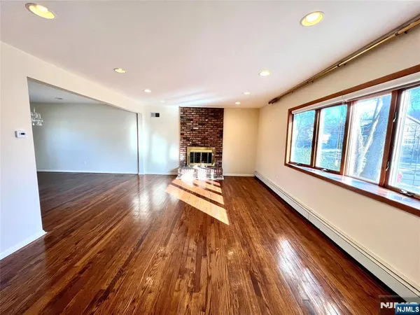 a view of a room with wooden floor and a window