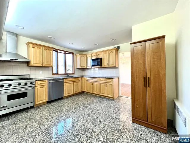 a kitchen with stainless steel appliances a refrigerator sink and cabinets