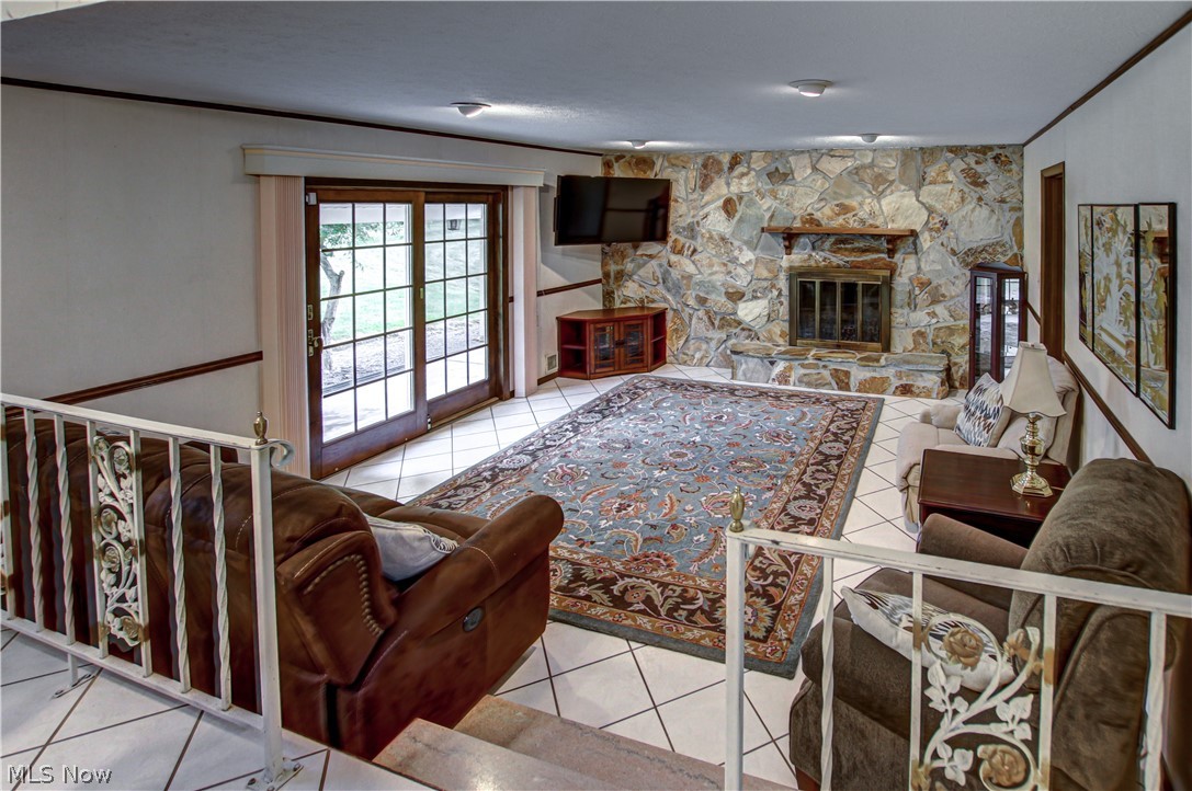 6013 Rousseau Drive Parma, OH 44129 - Photo 7 of 50 Family room featuring a stone fireplace and light tile flooring